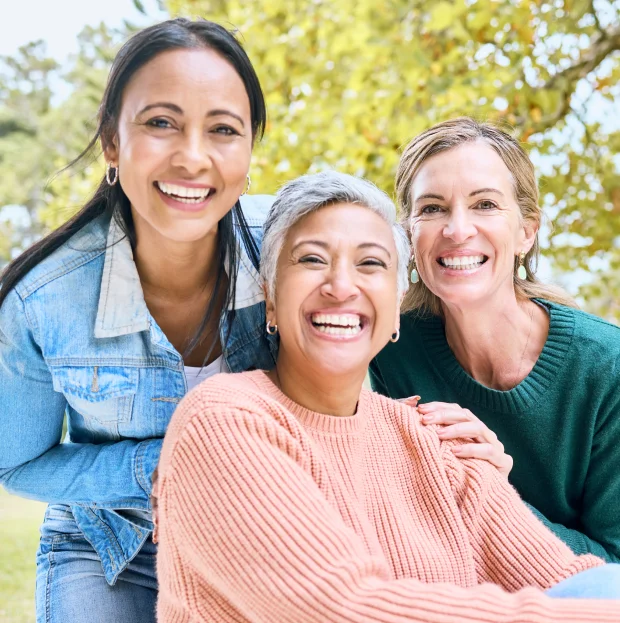 Three women smiling outdoors