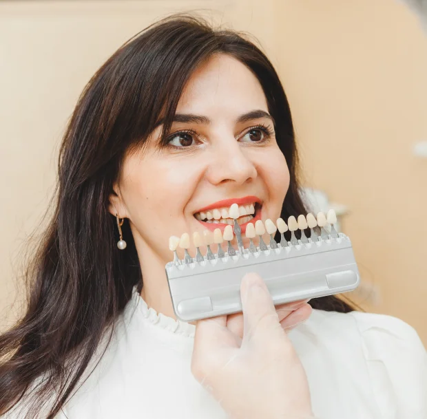 Woman holding dental veneer shade guide